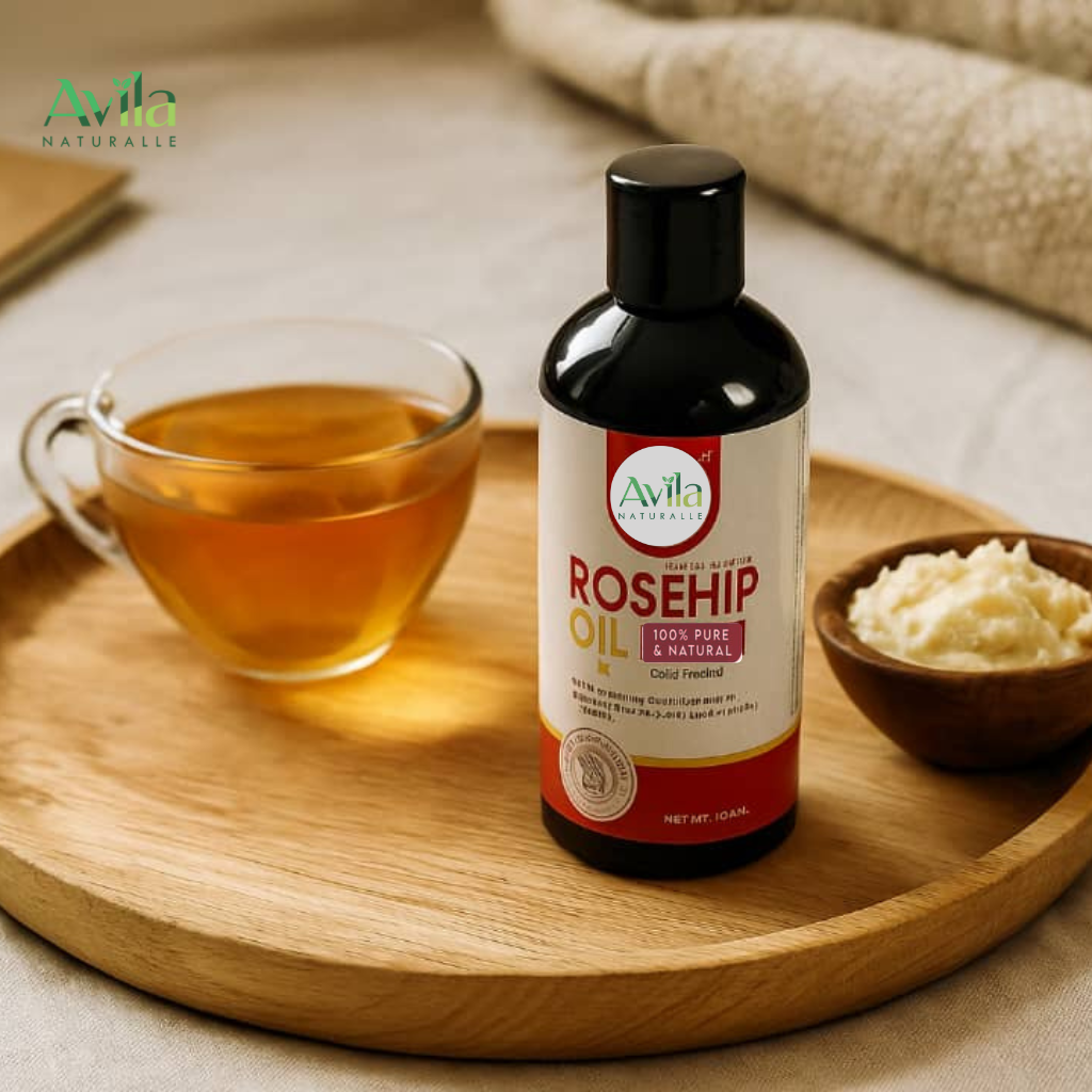 Beautiful display of Avila natural oils in glass bowl and glass bottles with a bowl of Shea butter representing the purity, richness, and skincare benefits of natural oils.